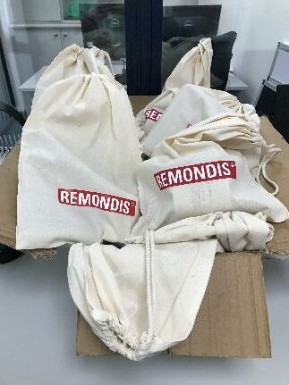 White cotton drawstring bags with REMONDIS logo