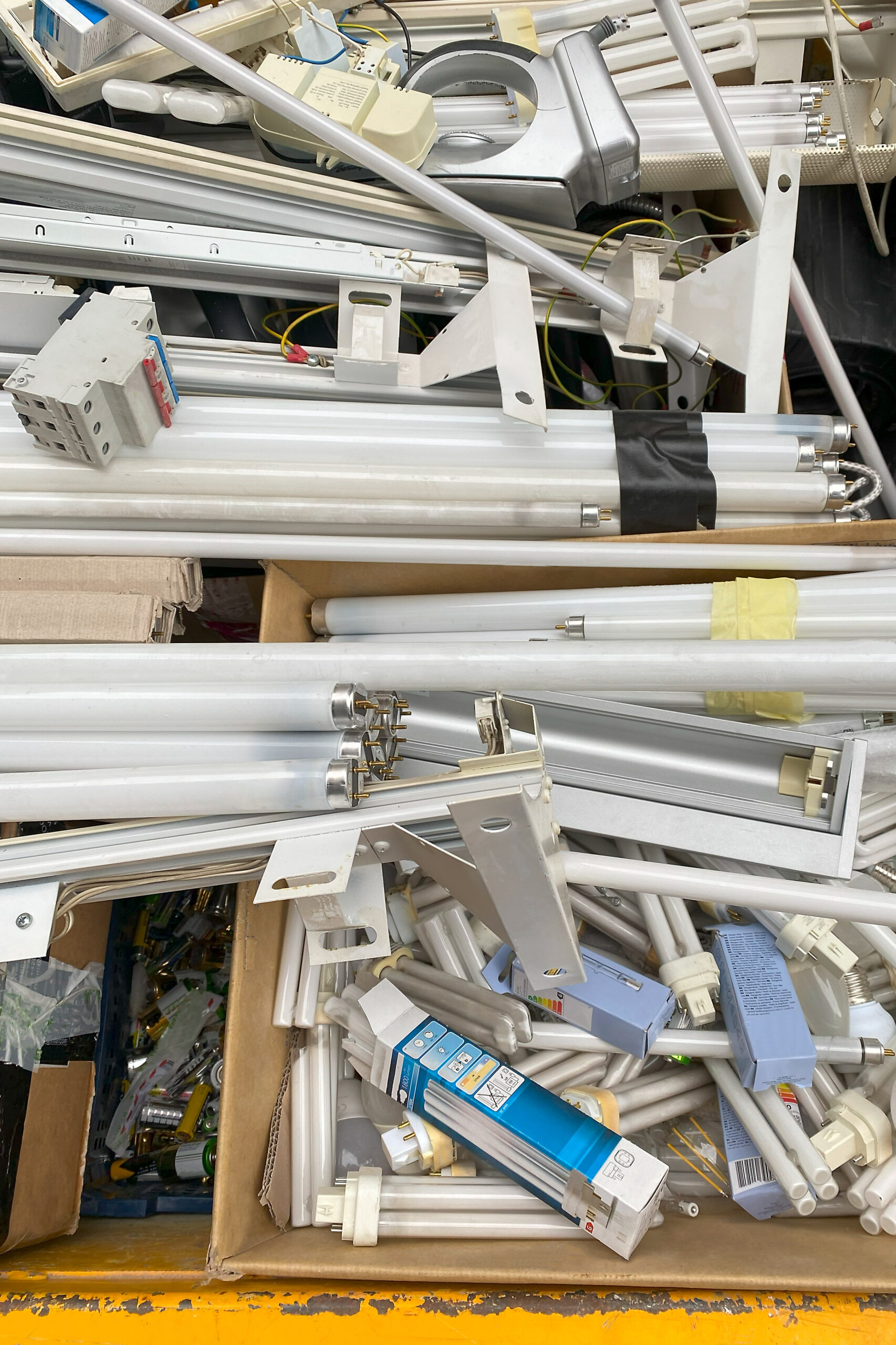 Pile of old used fluorescent tubes and electronic waste